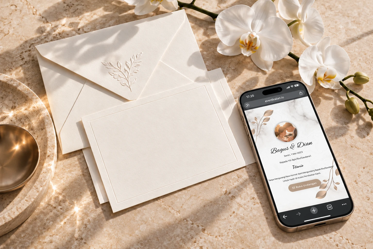 Event Kalian digital invitation open on a smartphone beside ivory stationery and orchids